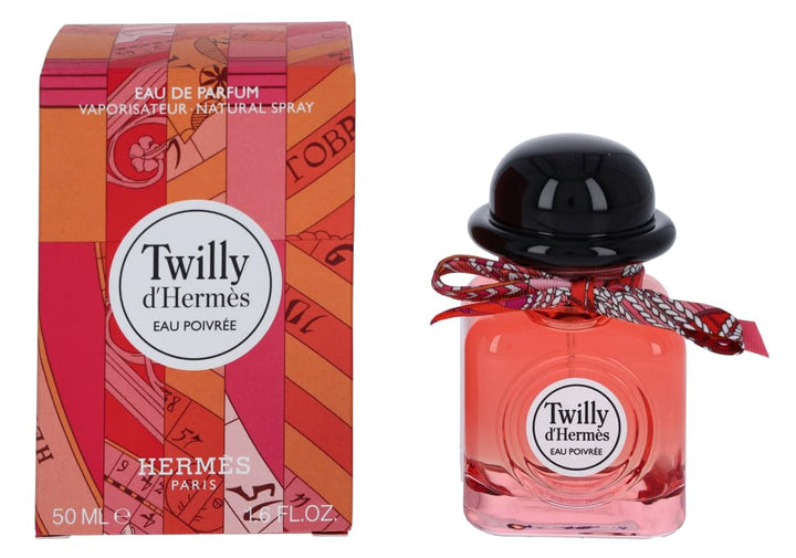 Square coral-tinted 50 ml bottle with hand-tied silk ribbon and spiced floral perfume