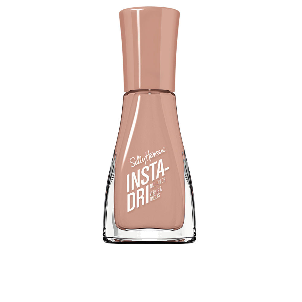 Nude pink nail polish in clear glass bottle with wide base, tapered neck, matching cap, printed white text, Sally Hansen