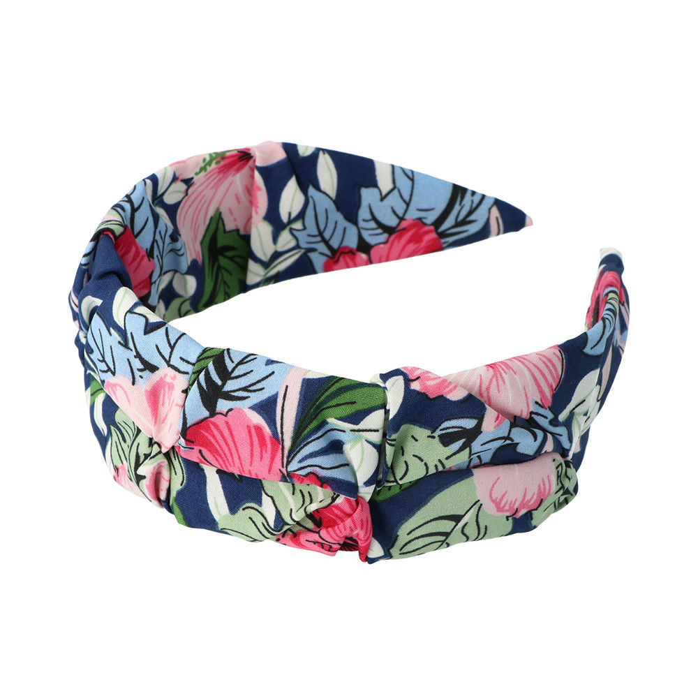 Inca Wide navy blue fabric headband with pink, green and white floral print and knotted detail
