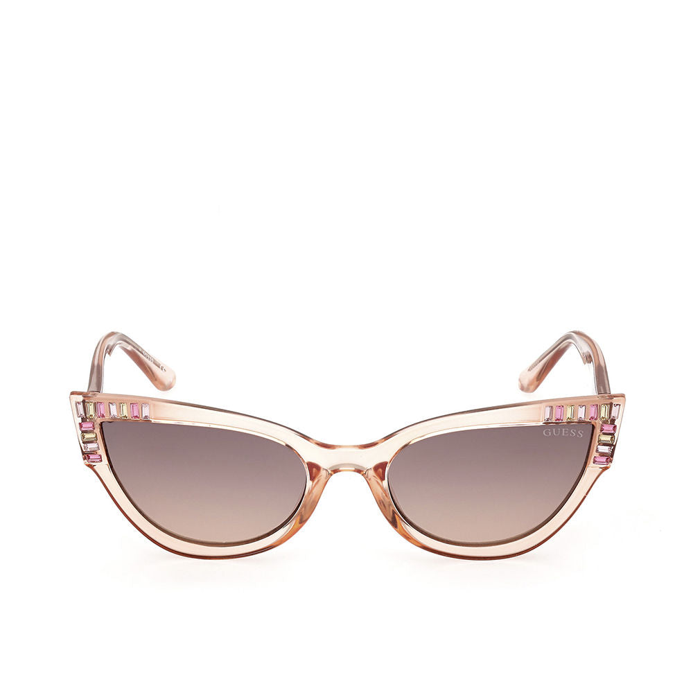 Light pink plastic cat-eye sunglasses with gradient brown lenses and decorative pink and clear stones — Guess.