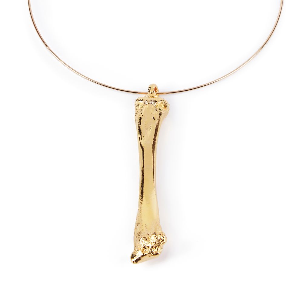 Gold‑plated rigid collar with 10 cm bone‑shaped pendant on brass hoop