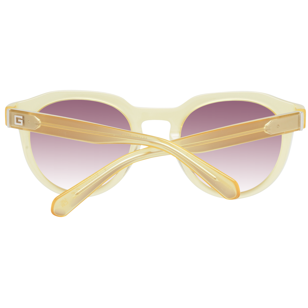 Yellow round sunglasses with purple gradient lenses and Guess logo on lens and temple