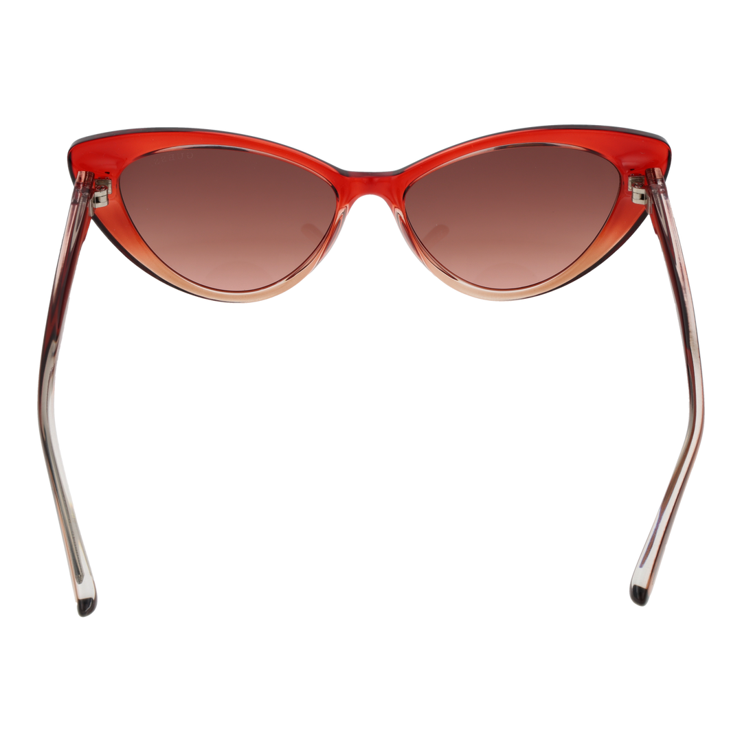 Transparent red cat-eye sunglasses in plastic with gradient lenses shown at three-quarter angle