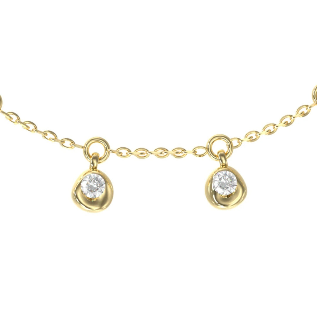 Delicate gold-tone pendant necklace with slim chain, dangling clear gemstone charms on display