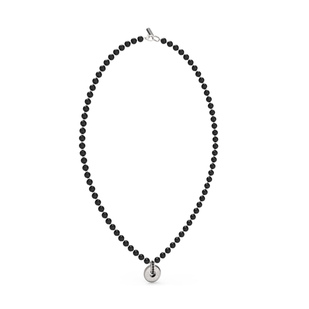 Black beaded metal chain necklace with polished round silver pendant on neutral background