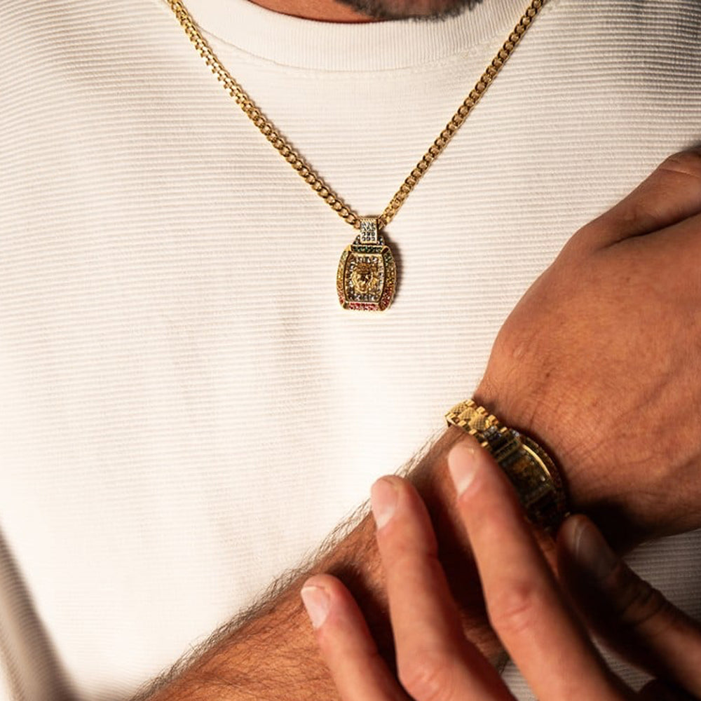 Gold lion head pendant on medium chain with multicolor accents, shown against neutral background