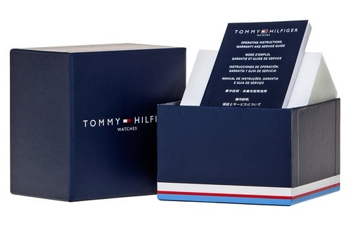 Silver stainless steel mesh watch with green dial and three subdials on neutral background